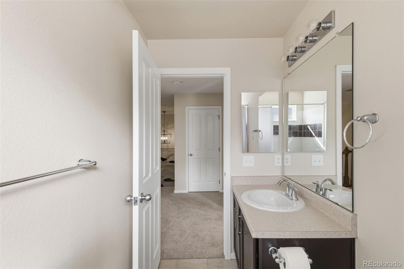 1150 Mircos Street Erie, CO 80516 - Photo 26 of 46 a bathroom with a sink and a mirror