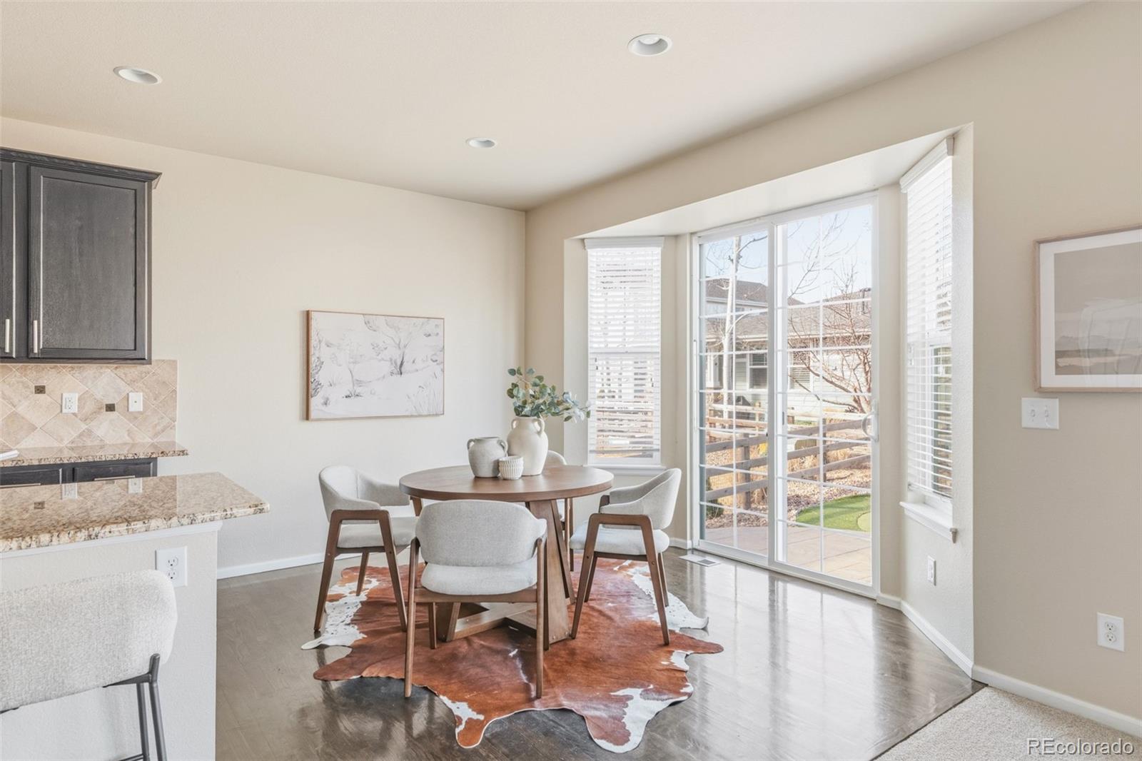 1150 Mircos Street Erie, CO 80516 - Photo 10 of 46 a view of a dining room with furniture and wooden floor