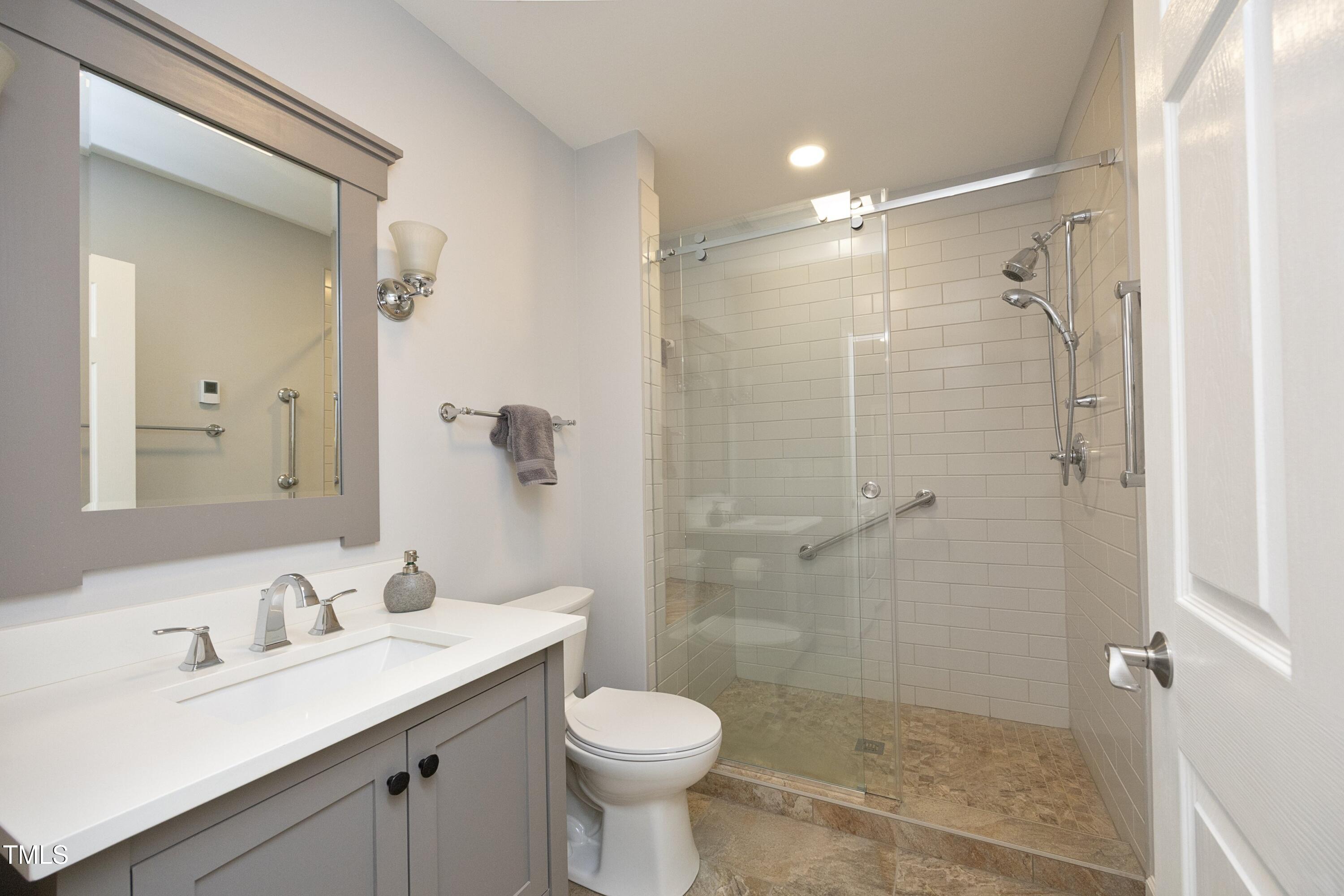 4616 Oak Park Road Raleigh, NC 27612 - Photo 24 of 63 Full first floor bath with walk-in shower & heated ceramic flooring