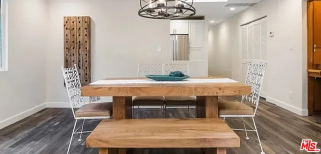 a room with table chairs and wooden floor
