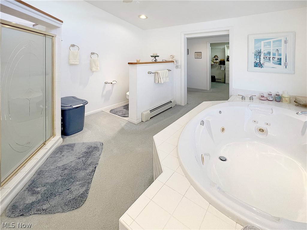 4663 East Harbor Road Port Clinton, OH 43452 - Photo 20 of 31 Bathroom featuring toilet, an enclosed shower, and baseboard heating