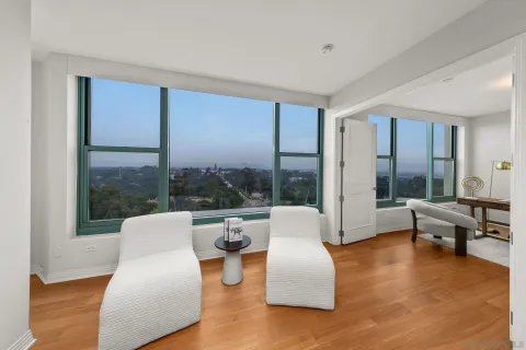 a living room with fireplace furniture and a large window