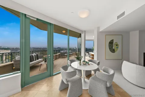 a living room with furniture a clock and a fireplace