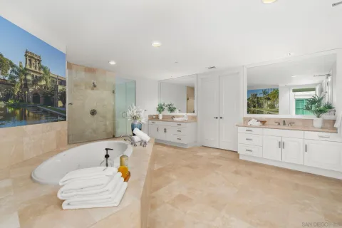 a large bed sitting in a bedroom next to a window