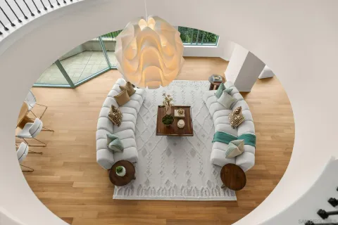 a living room with a balcony a bed and a couch