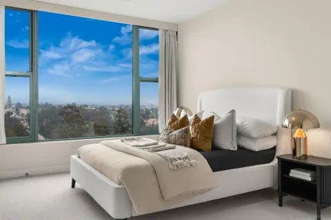 a living room with a table chairs and refrigerator