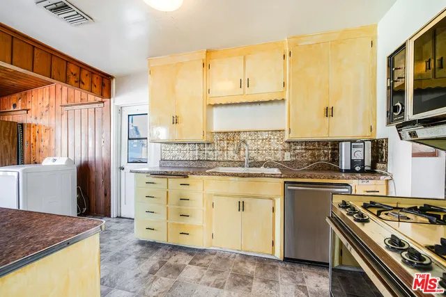 a large white kitchen with a large window