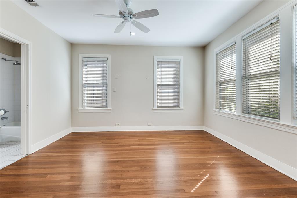 4144 Prescott Avenue Dallas, TX 75219 - Photo 11 of 12 a view of an empty room with wooden floor and a window