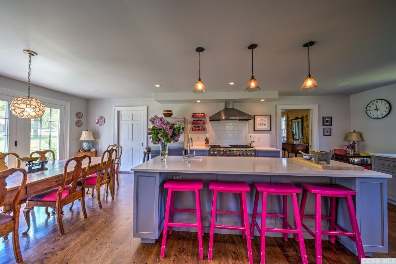 600 Chestnut Ridge Road Dover, NY 12522 - Photo 5 of 10 a kitchen with stainless steel appliances granite countertop a dining table chairs and white cabinets