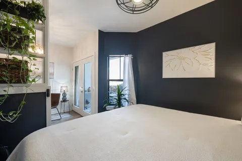 a bedroom with a bed and a window