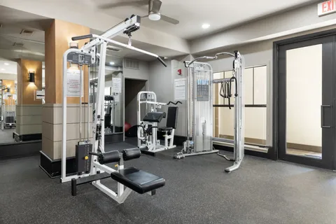 a view of a patio with chairs and umbrellas