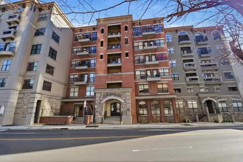 a view of a building with retail shops and a clock on the wall