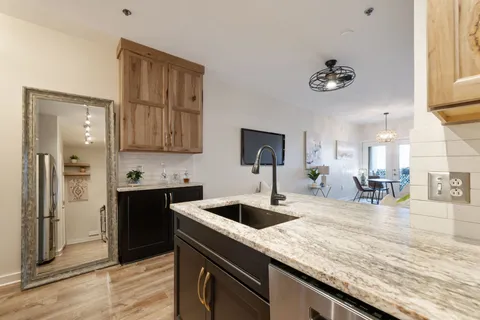 a kitchen with a refrigerator a sink and a stove