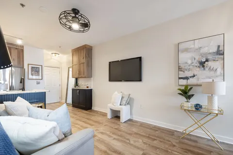 a living room with furniture and a flat screen tv