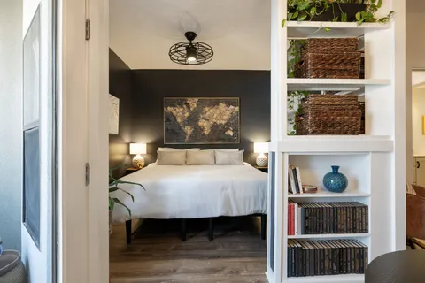 a bedroom with a bed and a window