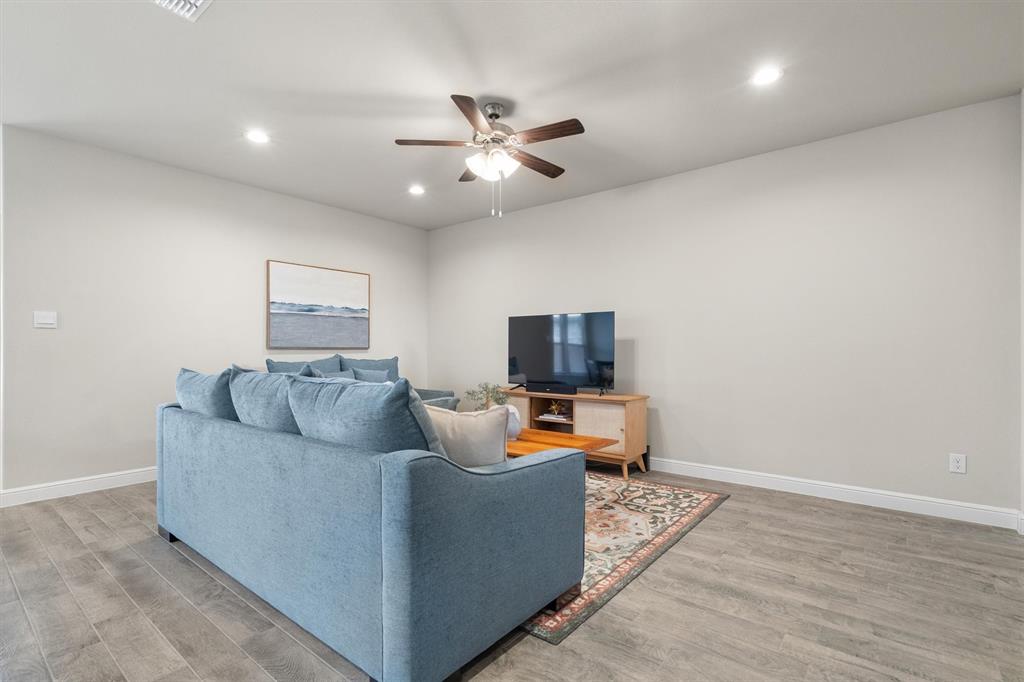 1864 Mensa Drive Haslet, TX 76052 - Photo 10 of 40 a living room with furniture and a flat screen tv