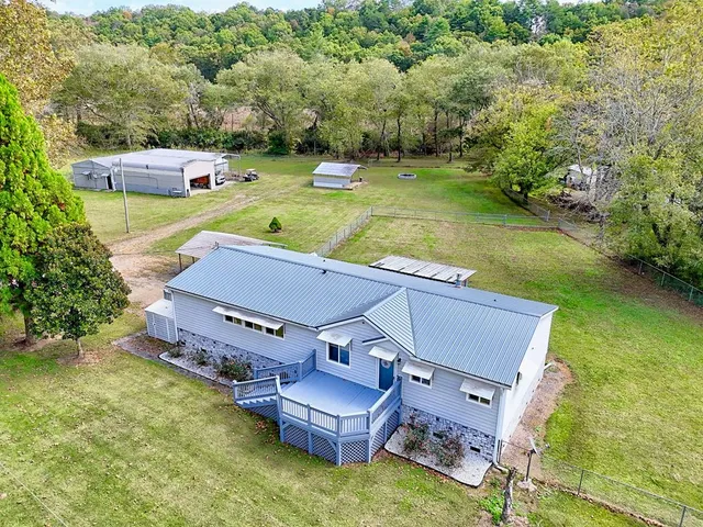 an aerial view of a house with swimming pool garden and mountain view