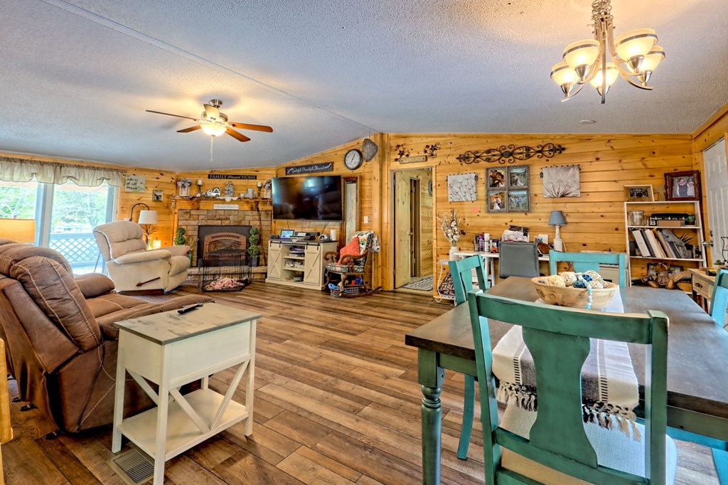 1483 Hilltop Road Murphy, NC 28906 - Photo 11 of 74 a view of a dining room with furniture a chandelier windows and wooden floor