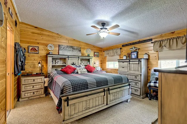 a bedroom with bed and a chandelier