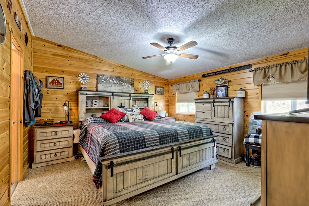 1483 Hilltop Road Murphy, NC 28906 - Photo 13 of 74 a bedroom with bed and a chandelier