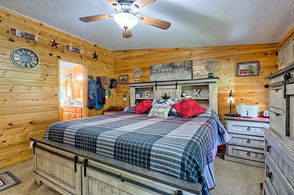 1483 Hilltop Road Murphy, NC 28906 - Photo 14 of 74 a bedroom with a bed and a chandelier