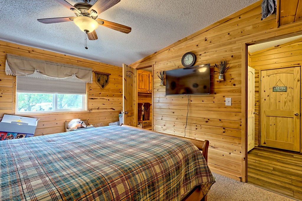 1483 Hilltop Road Murphy, NC 28906 - Photo 22 of 74 a bedroom with a bed and wooden floor