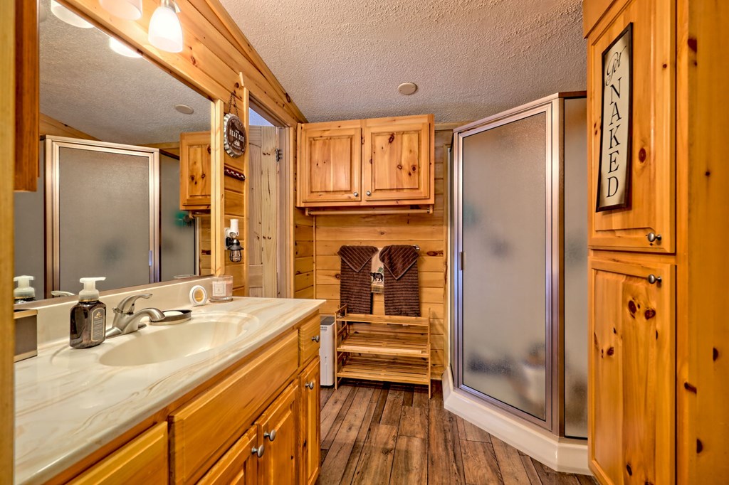 1483 Hilltop Road Murphy, NC 28906 - Photo 26 of 74 a bathroom with a granite countertop sink mirror and shower