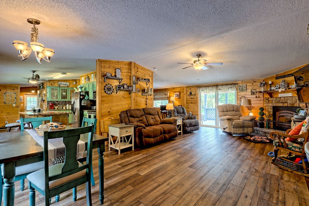 1483 Hilltop Road Murphy, NC 28906 - Photo 28 of 74 a living room with lots of furniture and a chandelier