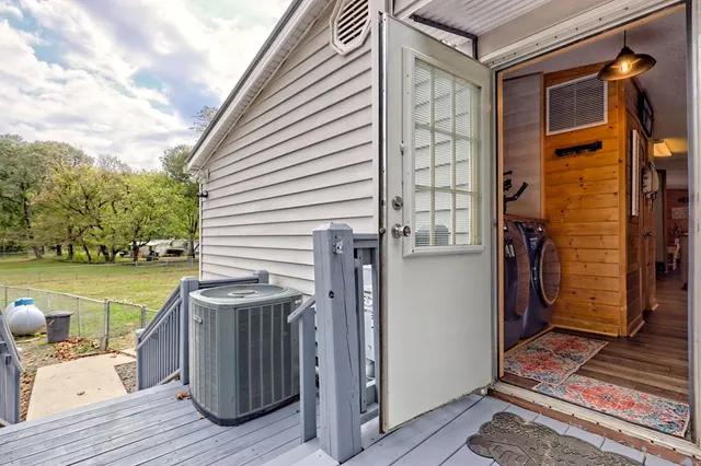 a living room with fireplace furniture and a large window