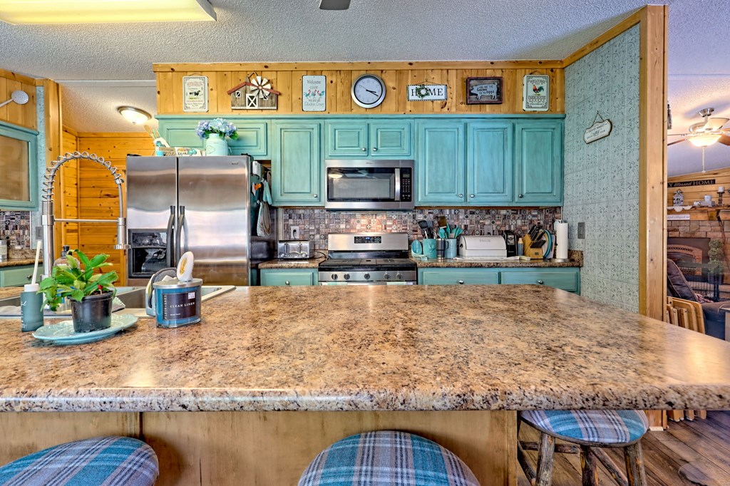 1483 Hilltop Road Murphy, NC 28906 - Photo 43 of 74 a kitchen with stainless steel appliances granite countertop a sink and cabinets
