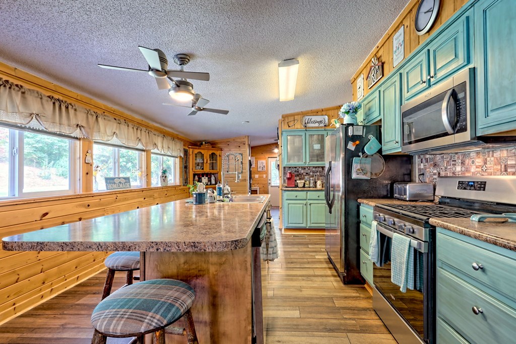 1483 Hilltop Road Murphy, NC 28906 - Photo 45 of 74 a kitchen with stainless steel appliances granite countertop a stove and a refrigerator