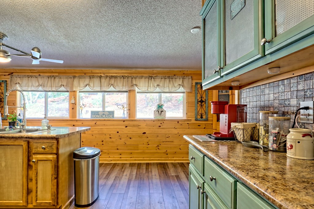 1483 Hilltop Road Murphy, NC 28906 - Photo 47 of 74 a kitchen with stainless steel appliances granite countertop a sink and wooden cabinets