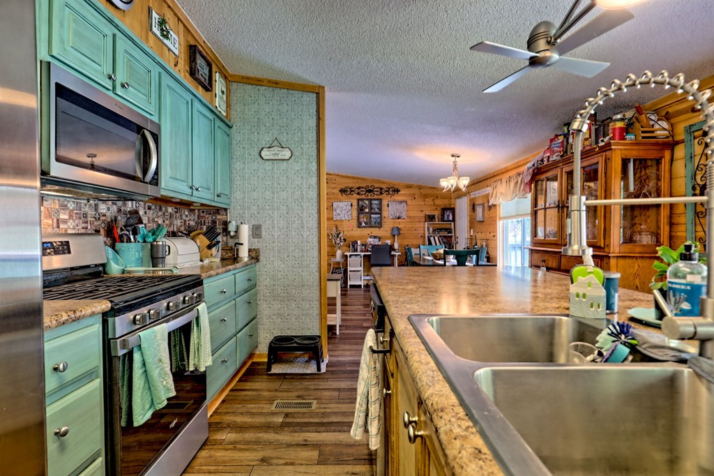 1483 Hilltop Road Murphy, NC 28906 - Photo 48 of 74 a kitchen with stainless steel appliances granite countertop a stove and a sink
