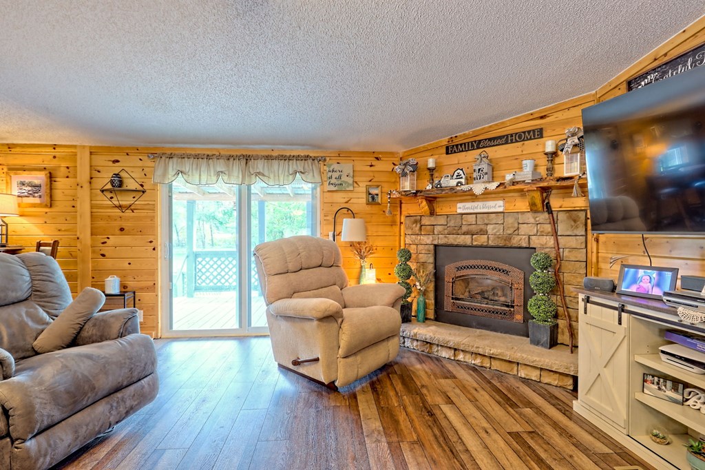 1483 Hilltop Road Murphy, NC 28906 - Photo 51 of 74 a living room with furniture a flat screen tv and a fireplace