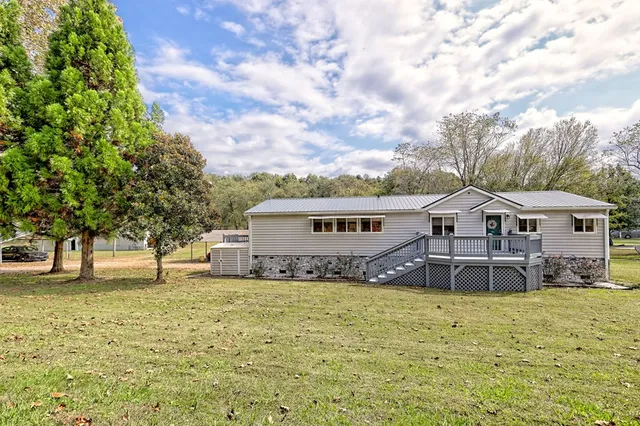 a house that has a tree in front of it