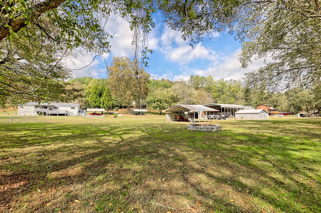 1483 Hilltop Road Murphy, NC 28906 - Photo 62 of 74 a white house with a big yard and large trees