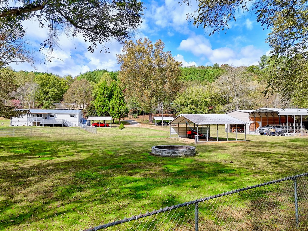1483 Hilltop Road Murphy, NC 28906 - Photo 7 of 74 a house view with swimming pool and trees in the background