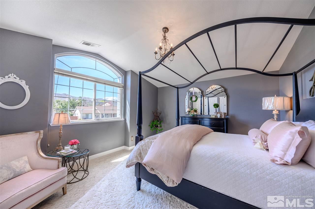 14225 Ghost Rider Drive Reno, NV 89511 - Photo 15 of 24 a bedroom with a bed and a large window with the outer view