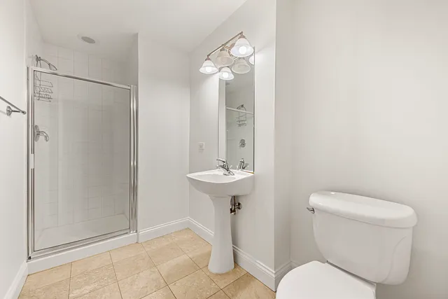 a bathroom with a toilet sink and shower