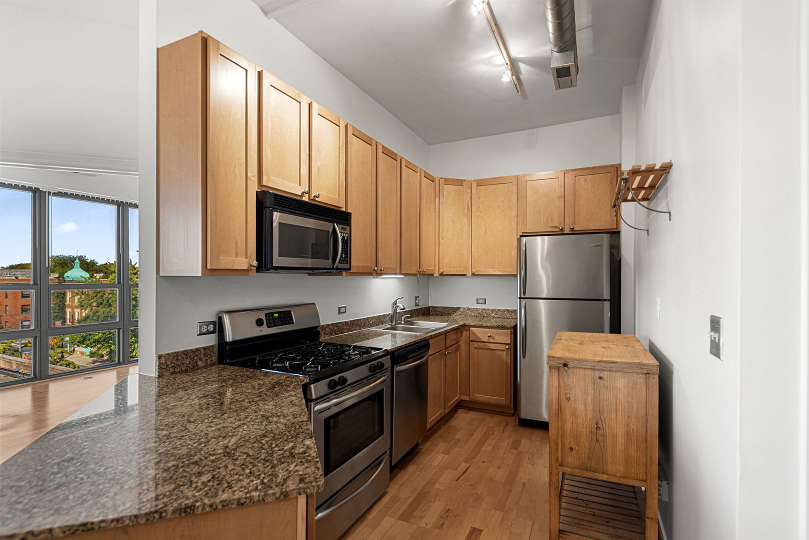4020 North Damen Avenue, Unit 404 Chicago, IL 60618 - Photo 5 of 17 a kitchen with stainless steel appliances granite countertop a refrigerator stove and microwave