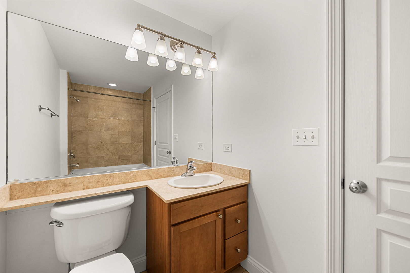 4020 North Damen Avenue, Unit 404 Chicago, IL 60618 - Photo 8 of 17 a bathroom with a sink a toilet a mirror and a shower