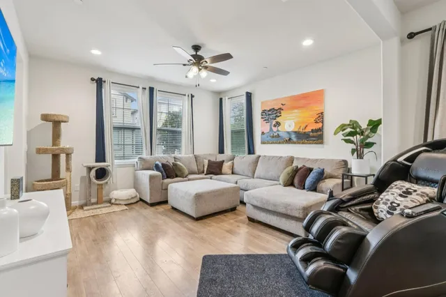 a living room with furniture ceiling fan and a rug