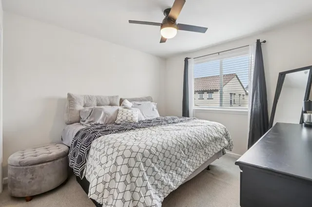 a bedroom with a large bed and a flat tv screen
