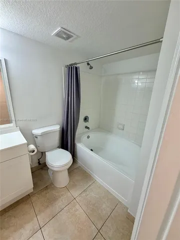 a bathroom with a toilet and a bathtub