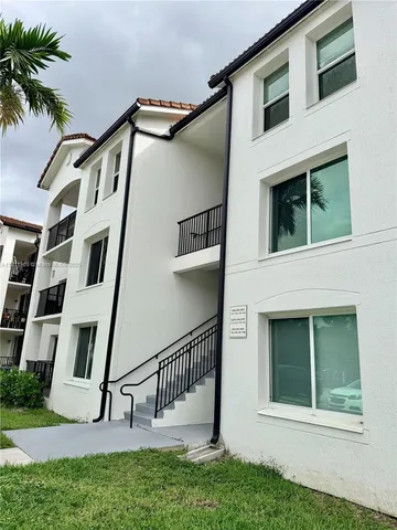 a view of a house with a yard and stairs