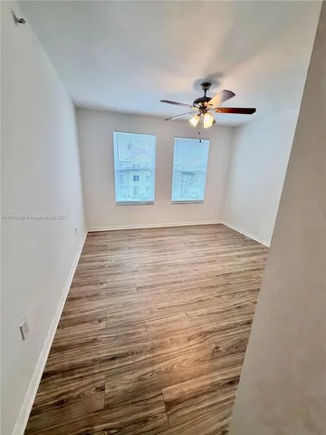 a view of a room with wooden floor