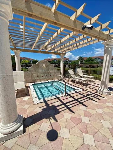 a view of a swimming pool with an outdoor seating and a yard