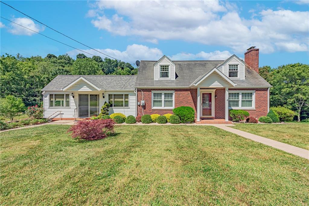 1431 New Stanton Ruffsdale Road Ruffs Dale, PA 15679 - Photo 1 of 25 a front view of a house with yard and green space