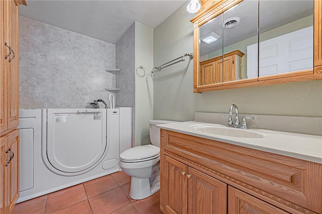 1431 New Stanton Ruffsdale Road Ruffs Dale, PA 15679 - Photo 12 of 25 a bathroom with a sink a toilet and a mirror