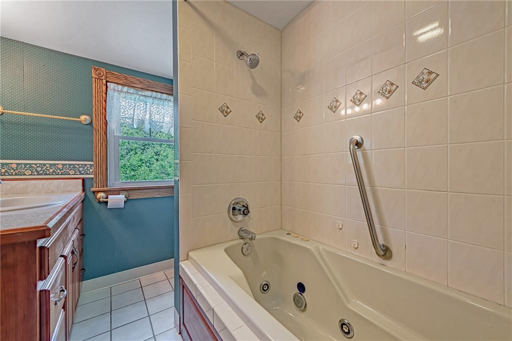 1431 New Stanton Ruffsdale Road Ruffs Dale, PA 15679 - Photo 18 of 25 a bathroom with a bathtub and a shower